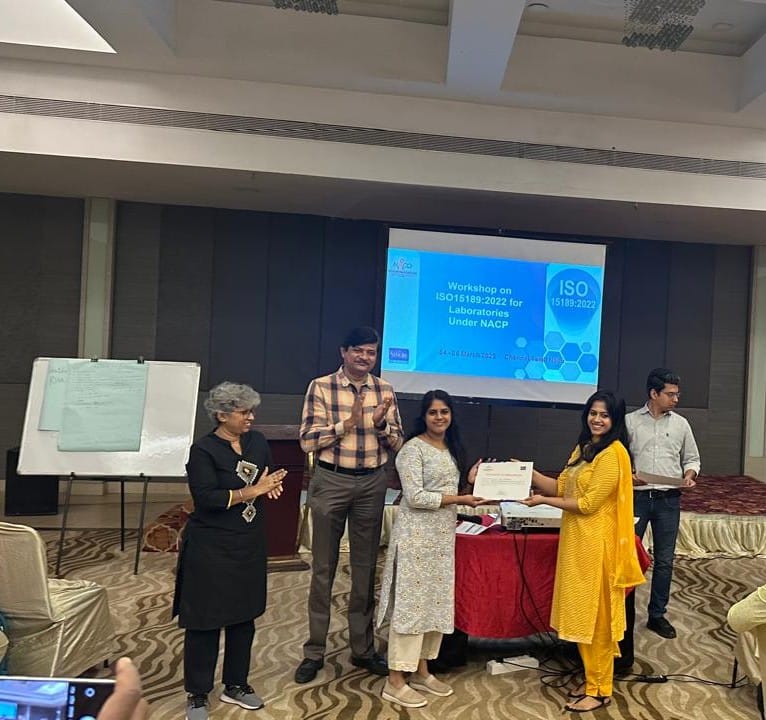 A lady receiving a certification from a senior lady at a workshop event