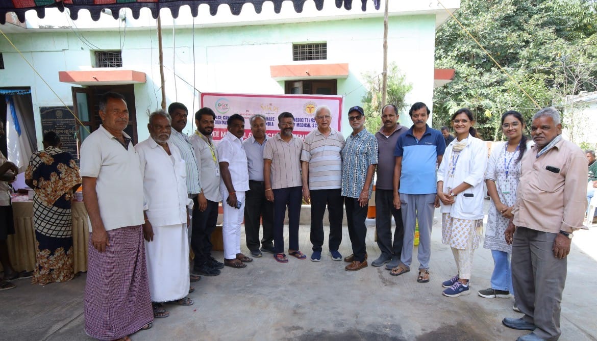 Group of community members and healthcare team posing together during medical camp event