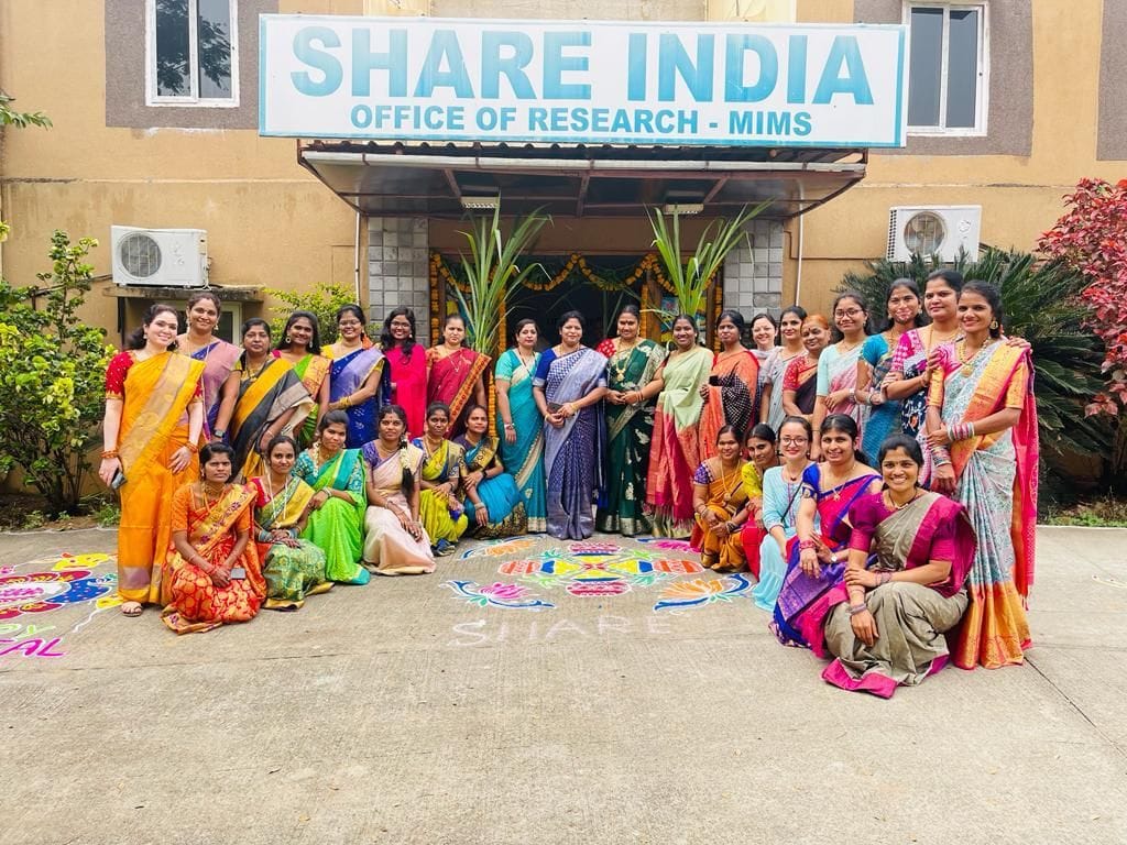 A group of ladies celebrating Women’s Day with rangoli