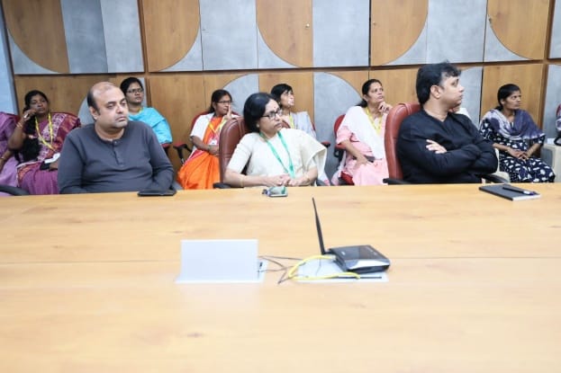 Participants attending meeting in conference room and listening to presentation