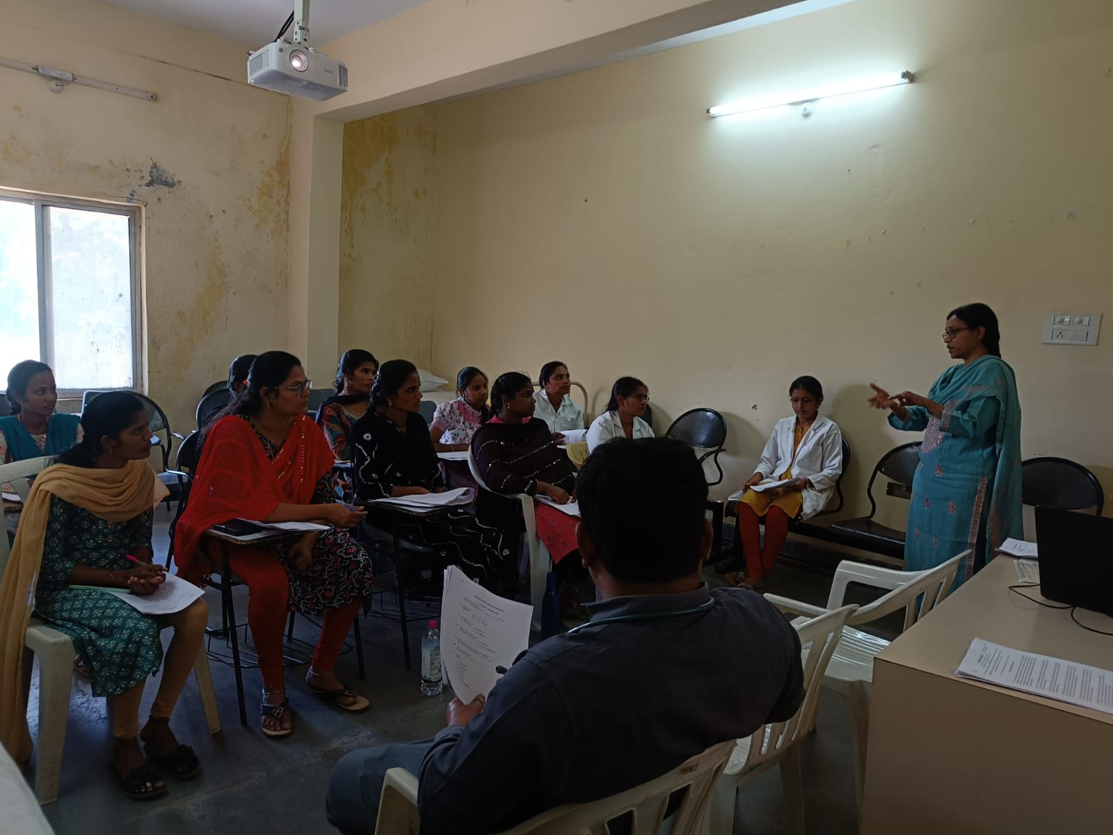 A female health instructor teaching in the class