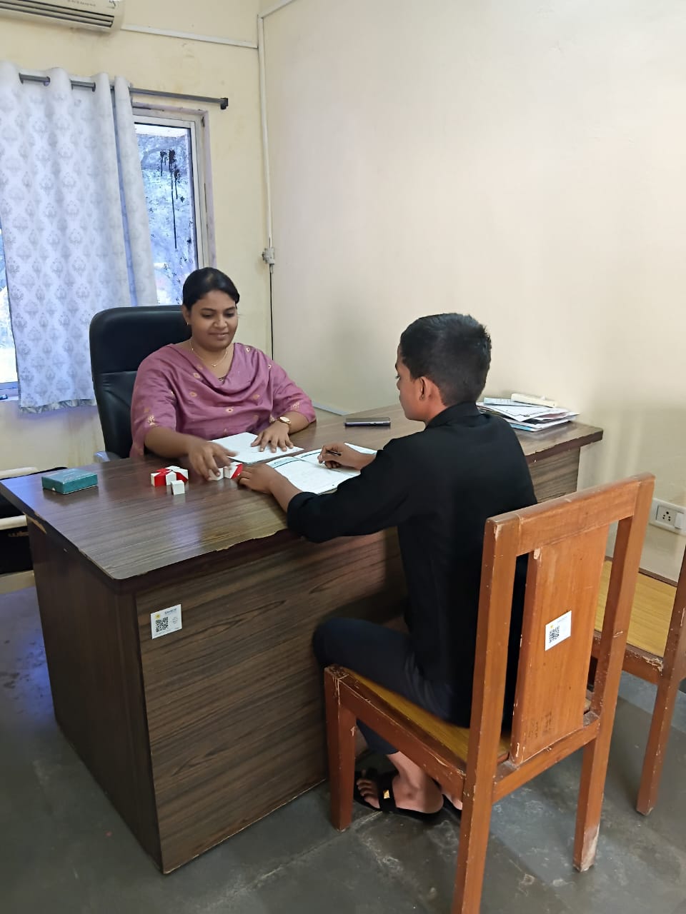 A health worker diagnosing a teenage boy