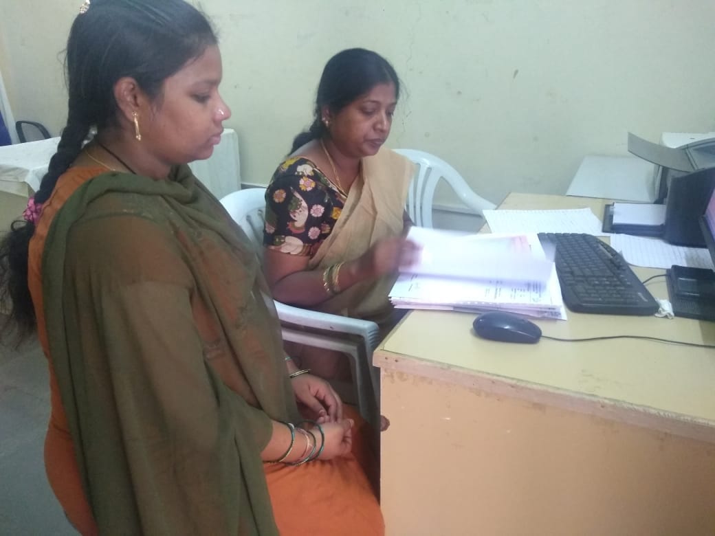 A health worker diagnosing a lady’s health report