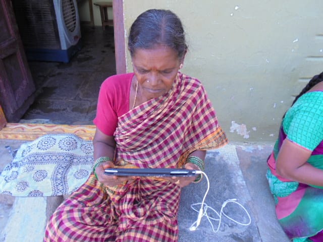 An old lady looking at a tablet screen