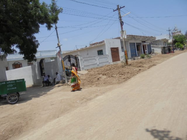 A health worker outside a house conducting a survey
