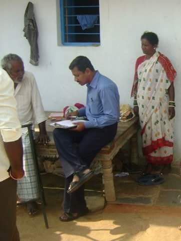 A health worker conducting a survey with an elderly man