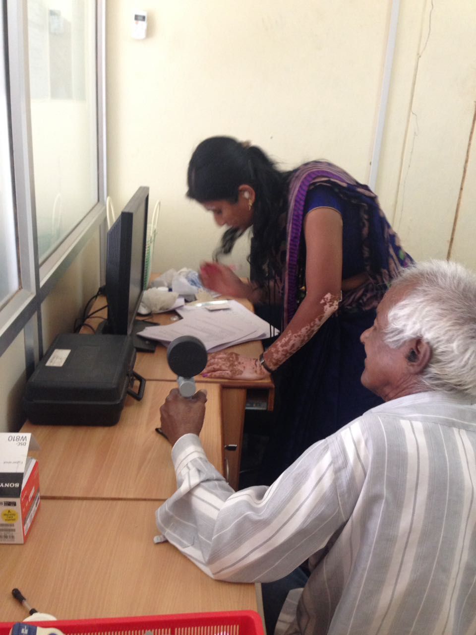 A health worker diagnosing an old man