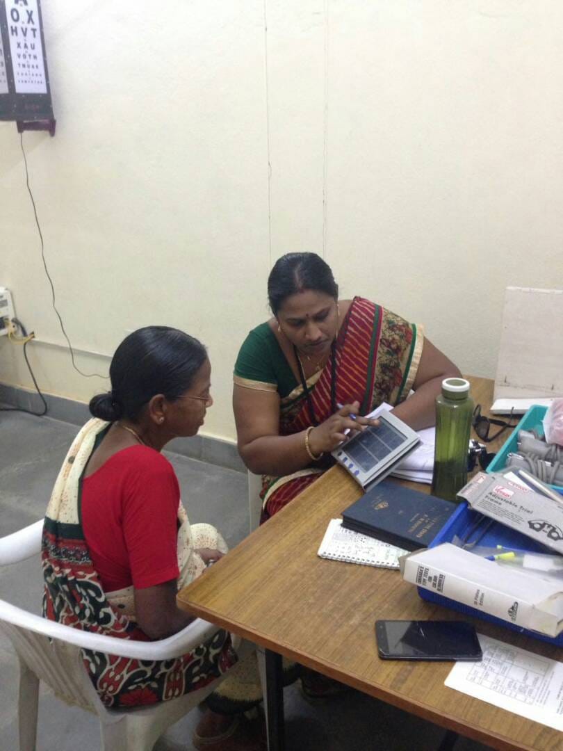 Healthcare worker measuring blood pressure of patient during clinic visit