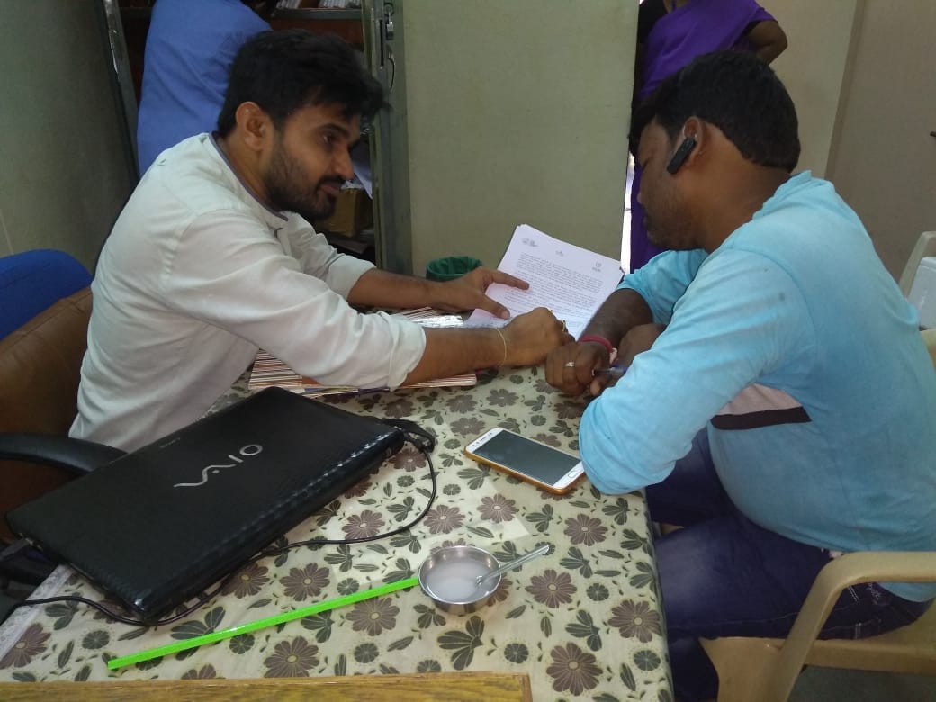 A health worker explaining the instructions to an old man
