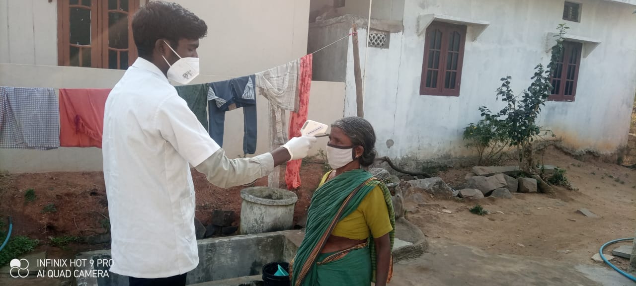 A health worker diagnosing an old lady
