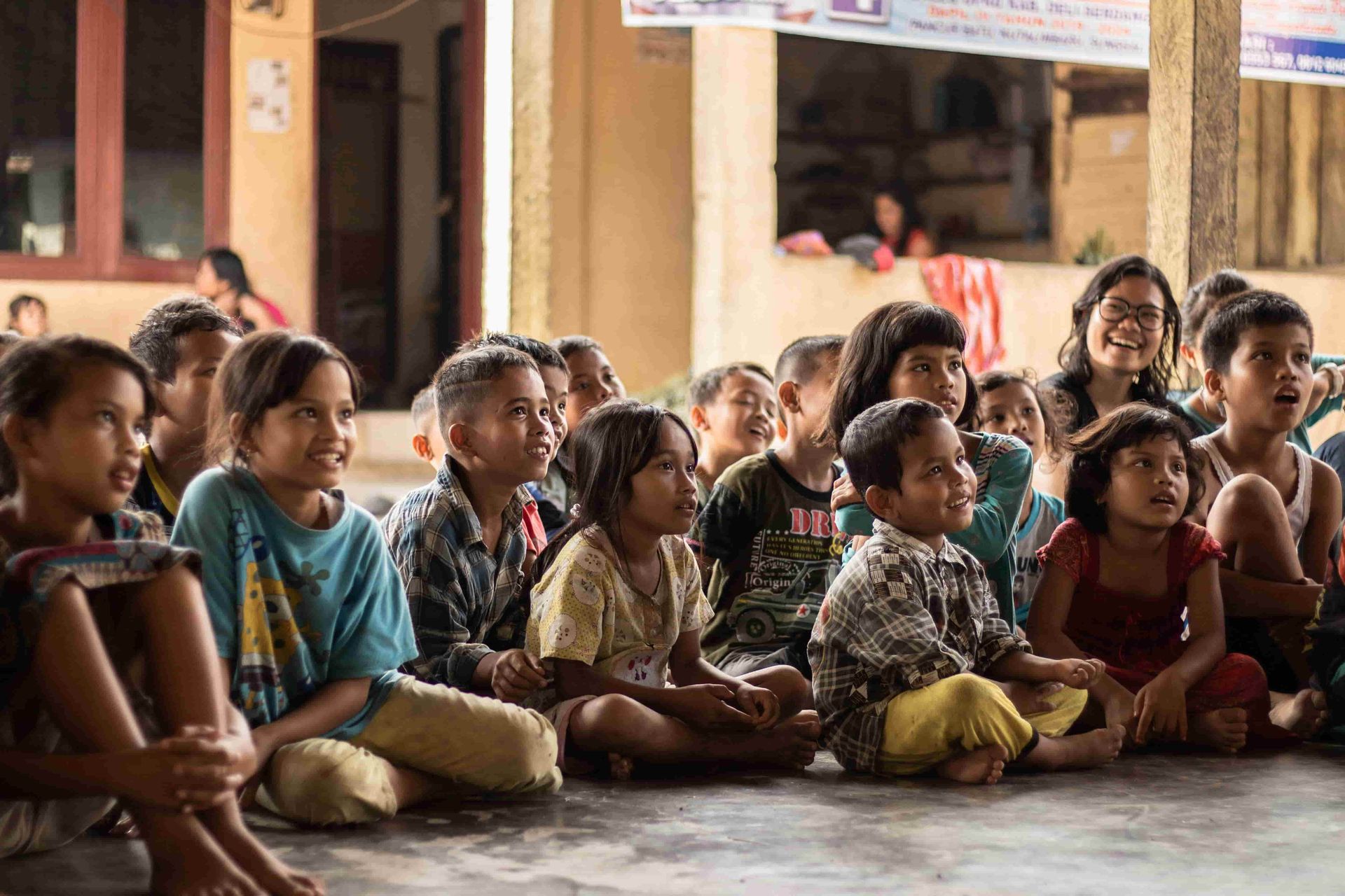 Children sitting together and smiling during group learning session