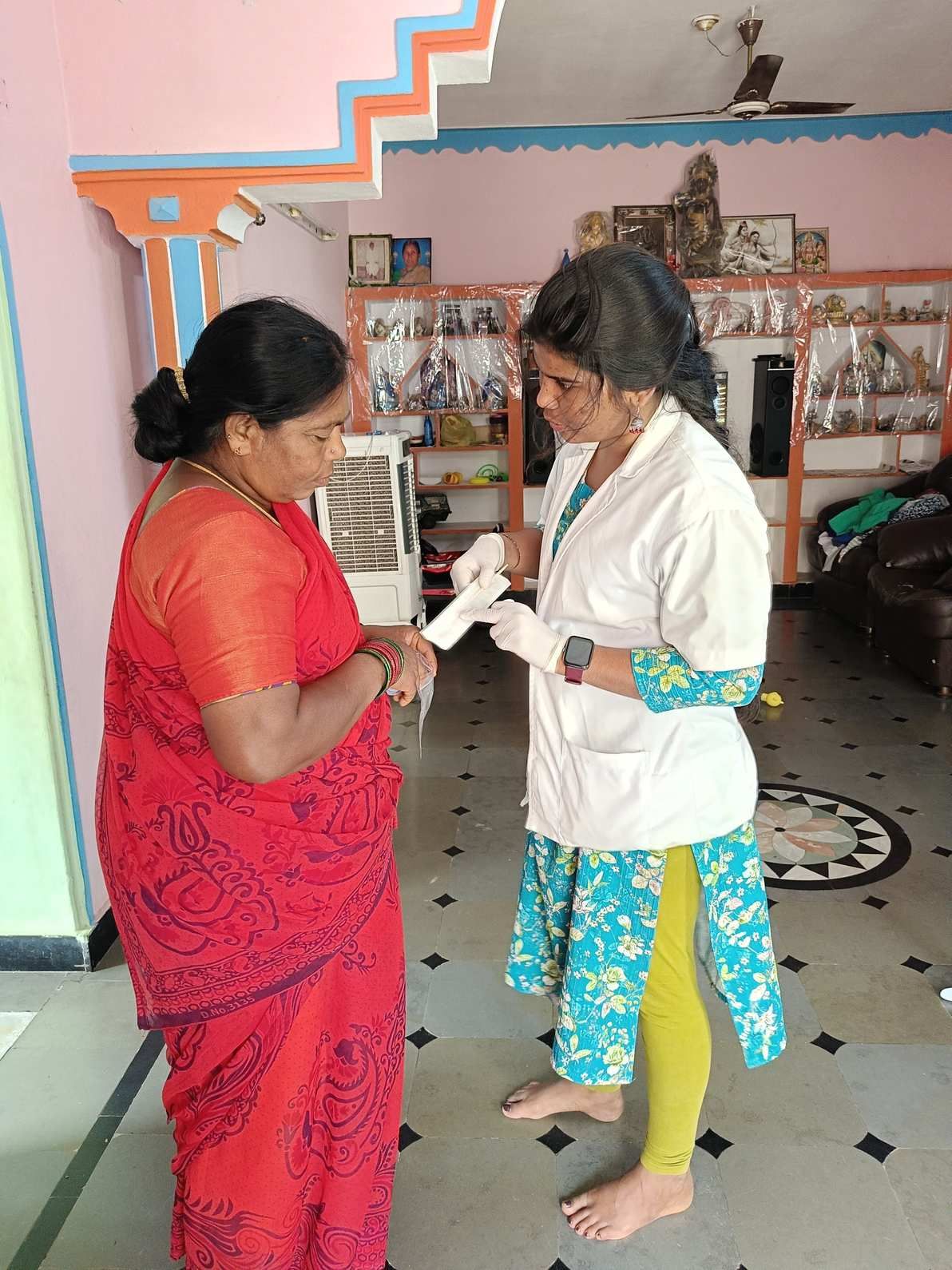A health worker explaining the instructions to a lady.