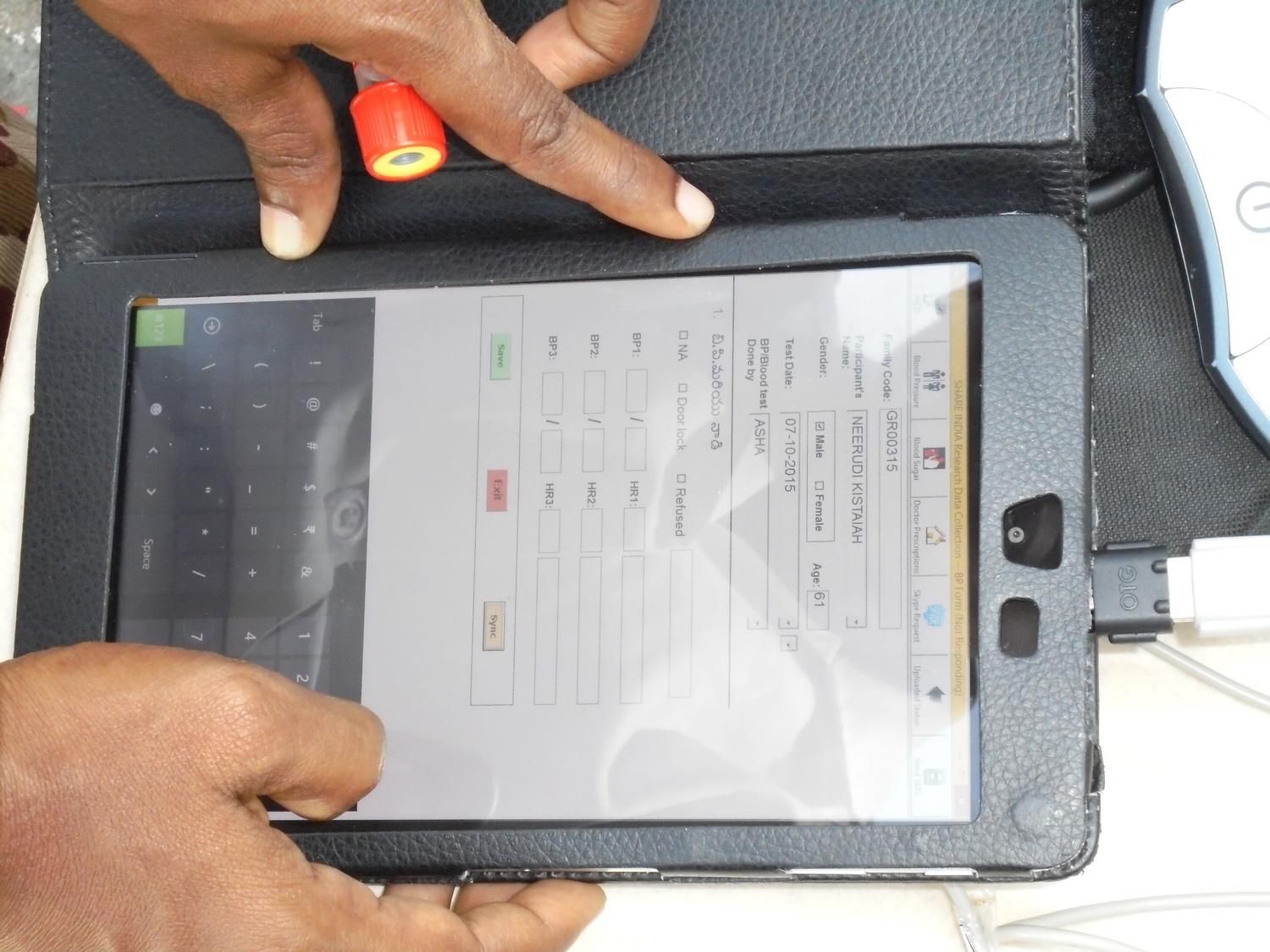Healthcare worker using a tablet device to enter patient information and manage digital medical records