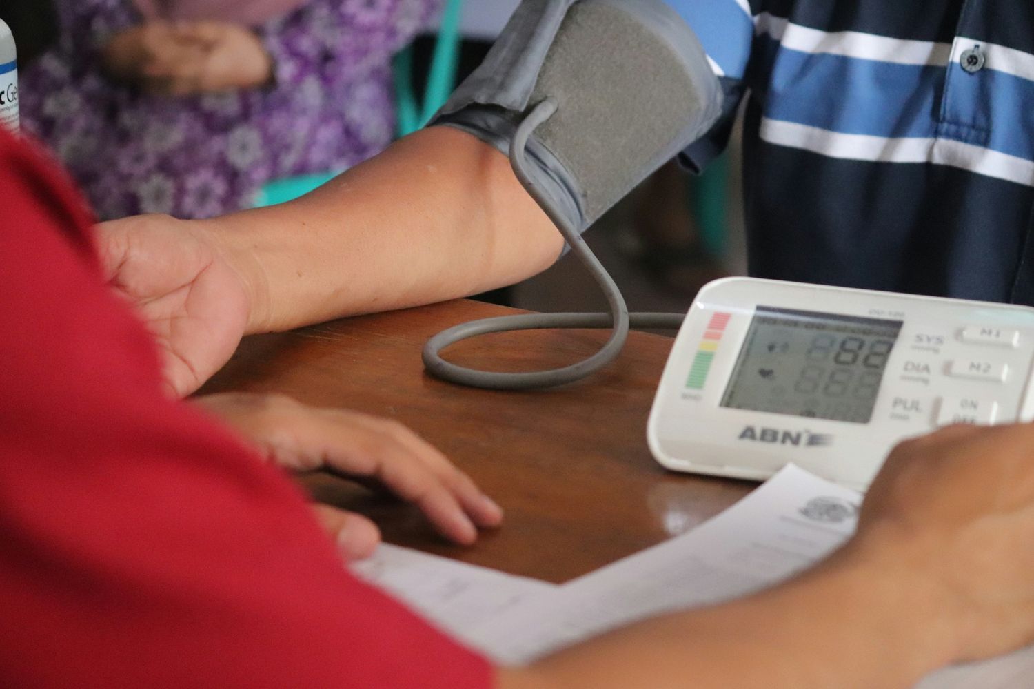 Blood pressure measurement being conducted using a digital monitor during a health check-up
