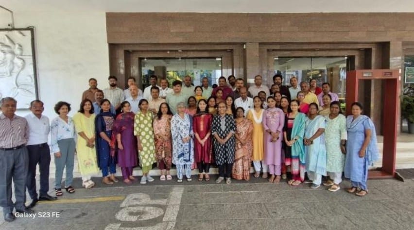 A large group of healthcare professionals posing together at a formal gathering or event.