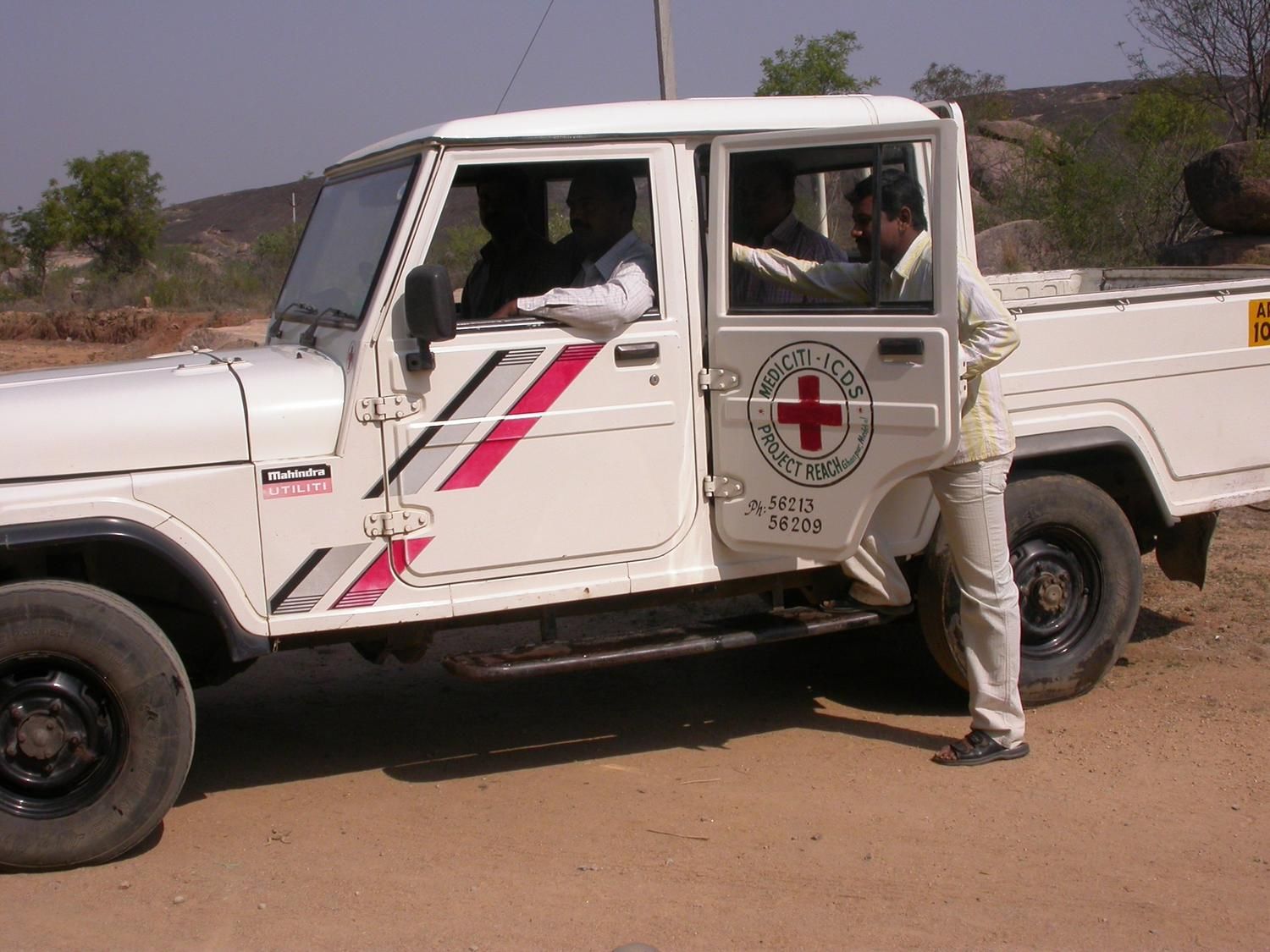 Healthcare worker performing a finger-prick blood glucose test for a patient during a home visit
