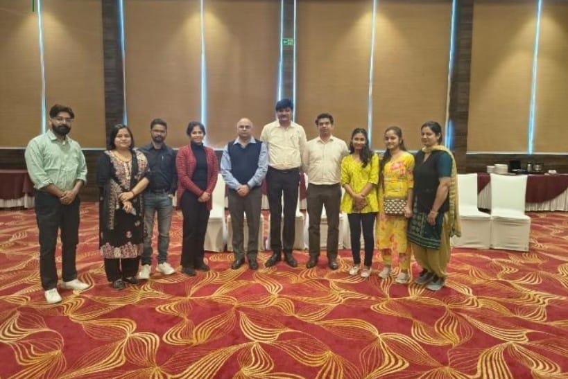 Group of professionals posing together during formal meeting