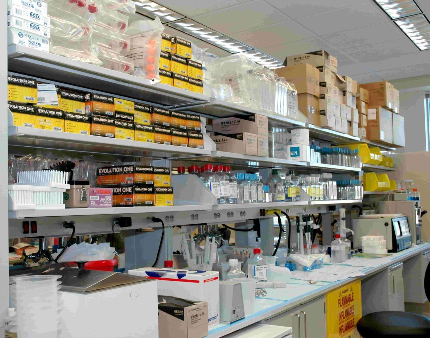 White wooden shelf with bottles and boxes. One of the laboratories in the Clinical Research Center
