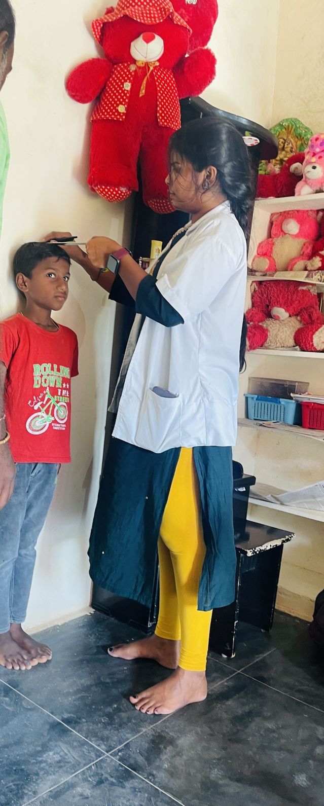 Healthcare worker measuring child’s height during growth assessment
