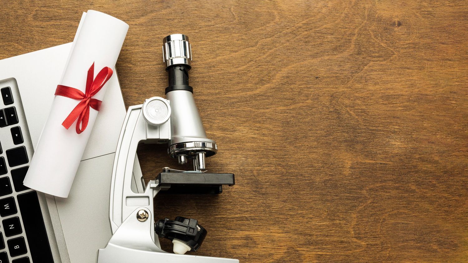 Top view laptop with microscope award and certificate