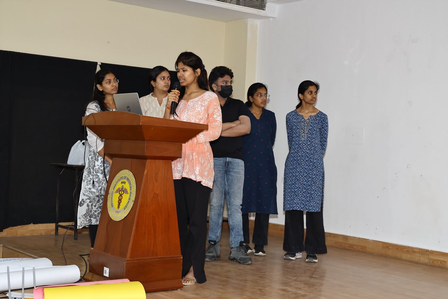 Student presenting with a microphone at a podium