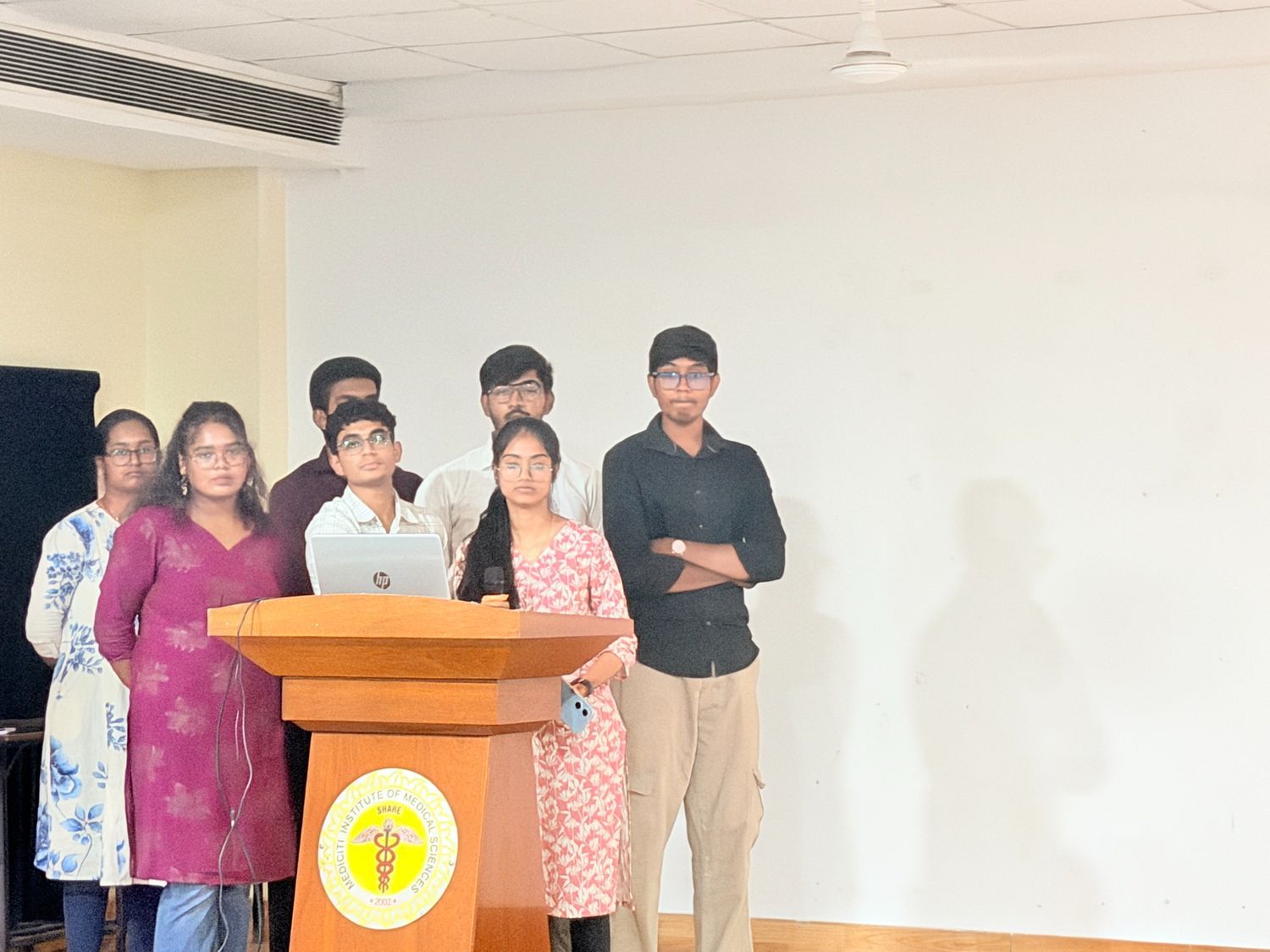 Student presenting with a microphone at a podium