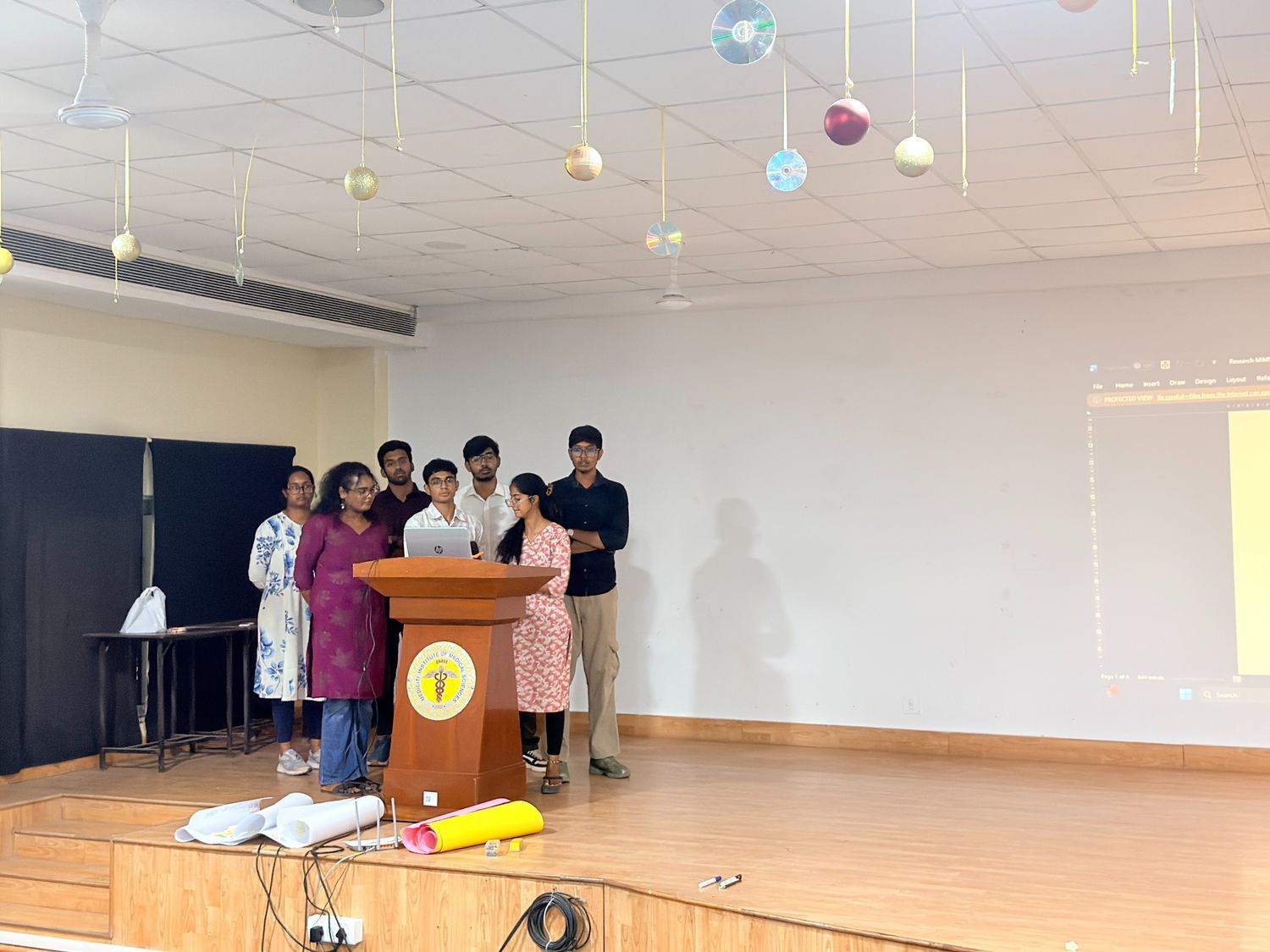 Student presenting with a microphone at a podium